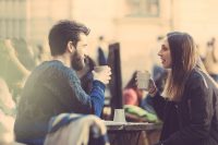 Hipster couple drinking coffee in Stockholm old town.