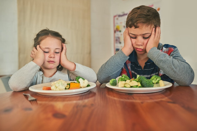 grumpy children refusing to eat their vegetables
