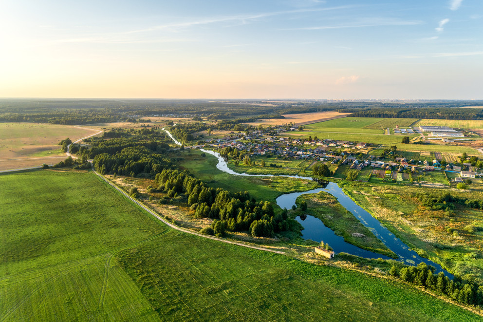 Aerial view. Small european village. Blue winding river.