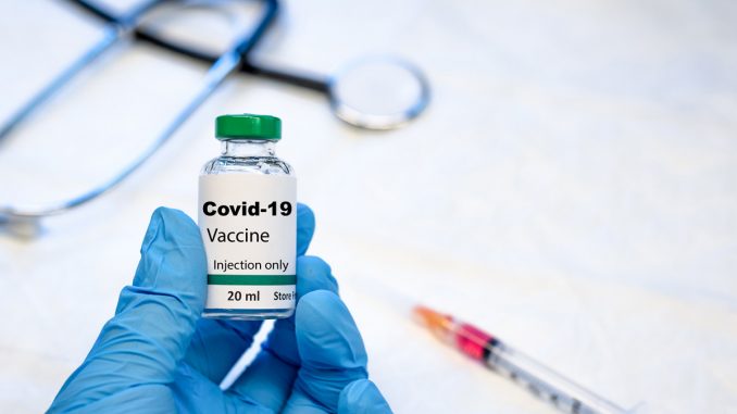 Covid-19 coronavirus vaccine vial with syringe and stethoscope
