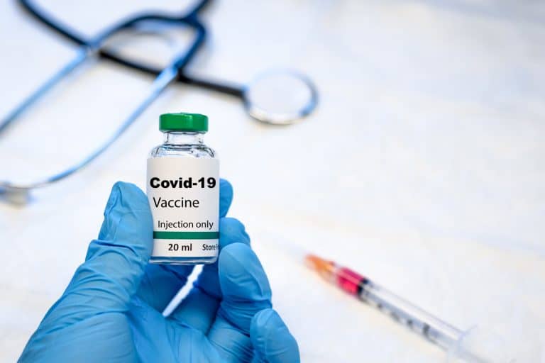 Covid-19 coronavirus vaccine vial with syringe and stethoscope