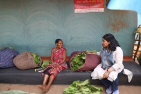 Roopa Roshan Sahoo interacting with a tribal woman